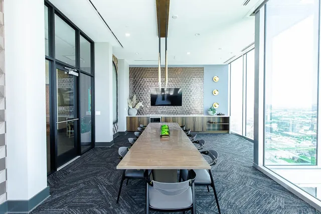 a living room with furniture and floor to ceiling window