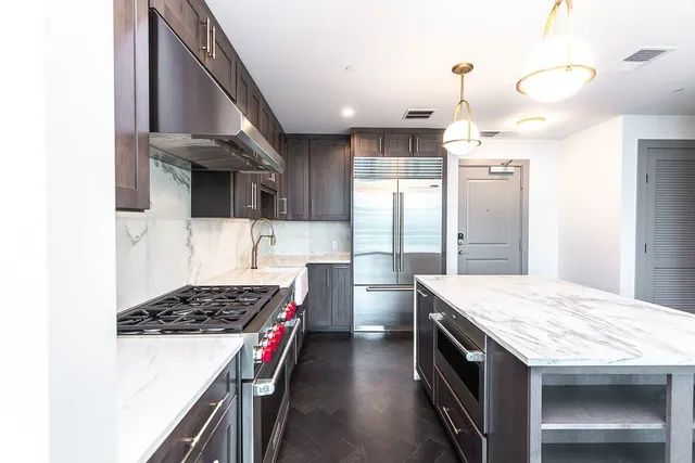 a kitchen with a sink stove and refrigerator