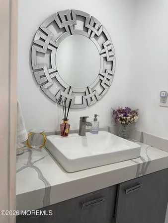 a bathroom with a sink and mirror