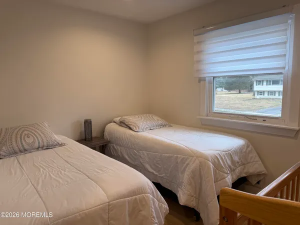 a bedroom with two beds and a window