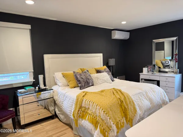 a bedroom with a bed and dresser