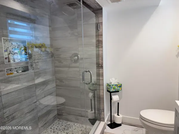 a bathroom with a toilet and a shower