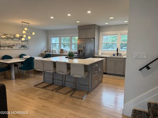 a large kitchen with kitchen island a sink table and chairs