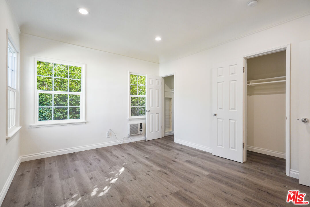 228 South Reeves Drive, Unit D Beverly Hills, CA 90212 - Photo 9 of 13 an empty room with wooden floor and windows