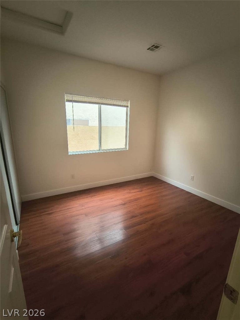 9725 Pima Point Avenue Las Vegas, NV 89147 - Photo 16 of 35 Well-lit room features durable hardwood flooring, ready for your personal touch.