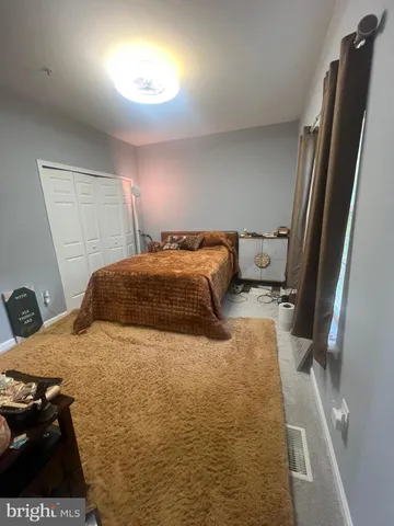 a bedroom with a bed and a mirror