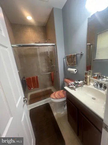 a bedroom with a bed a chair and a large window