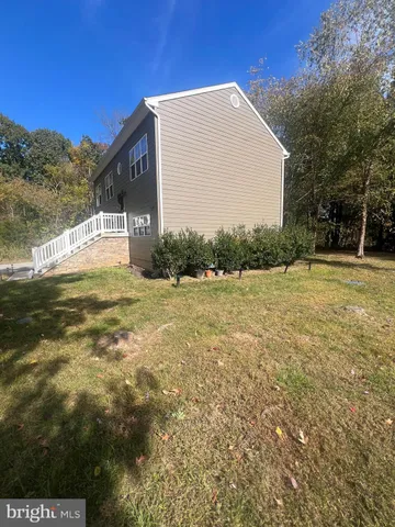 a backyard of a house with a large tree