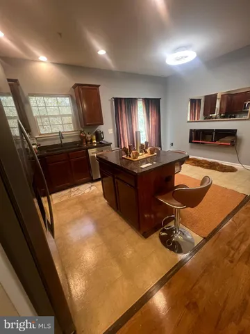 a room with furniture pool table and window