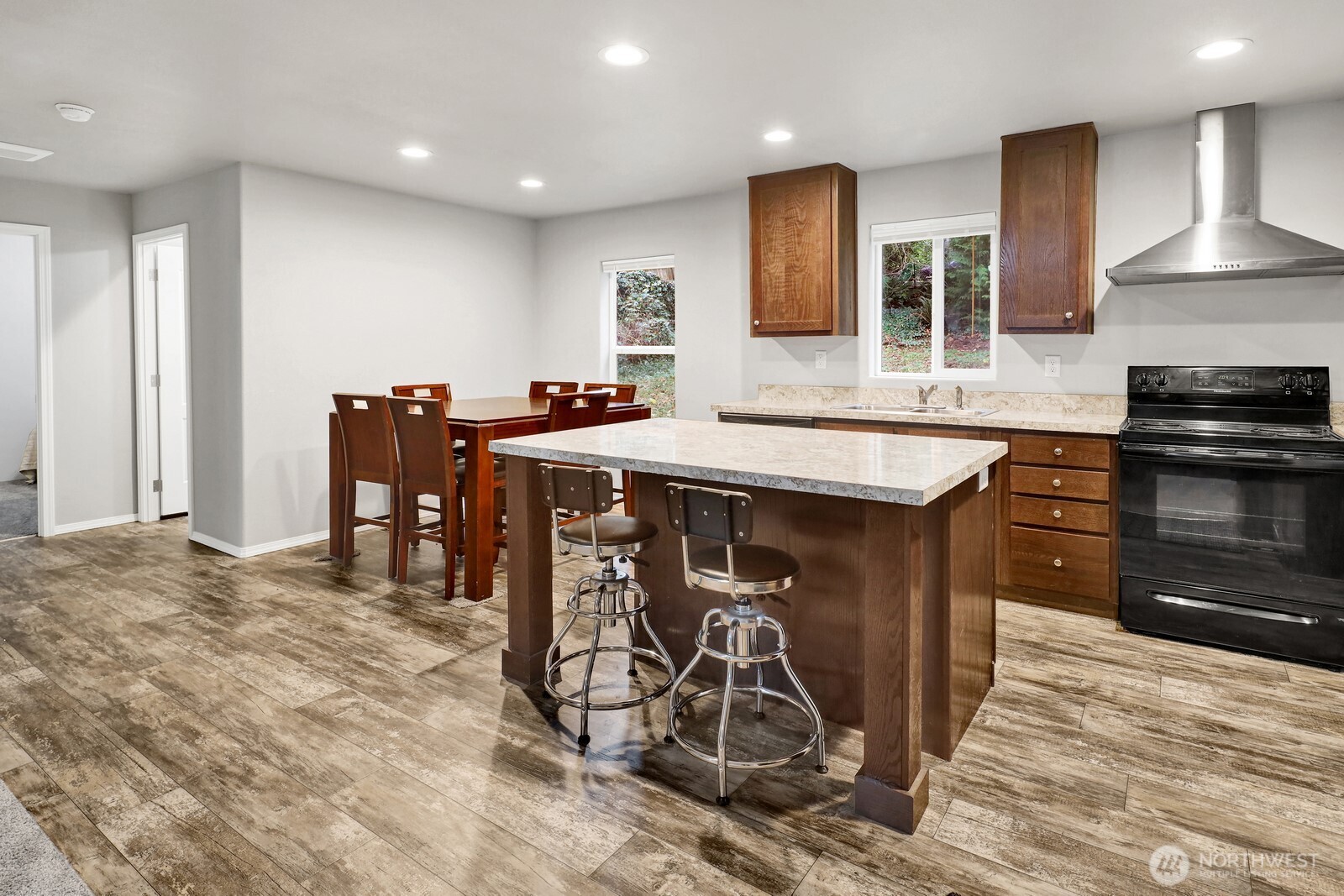 467 Cain Lake Road Sedro-Woolley, WA 98284 - Photo 11 of 28 a kitchen with stainless steel appliances granite countertop a stove top oven a sink a dining table and chairs