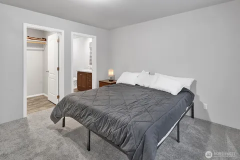 a bedroom with a bed and lamp