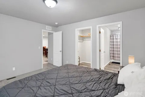 a bedroom with a bed and a chandelier