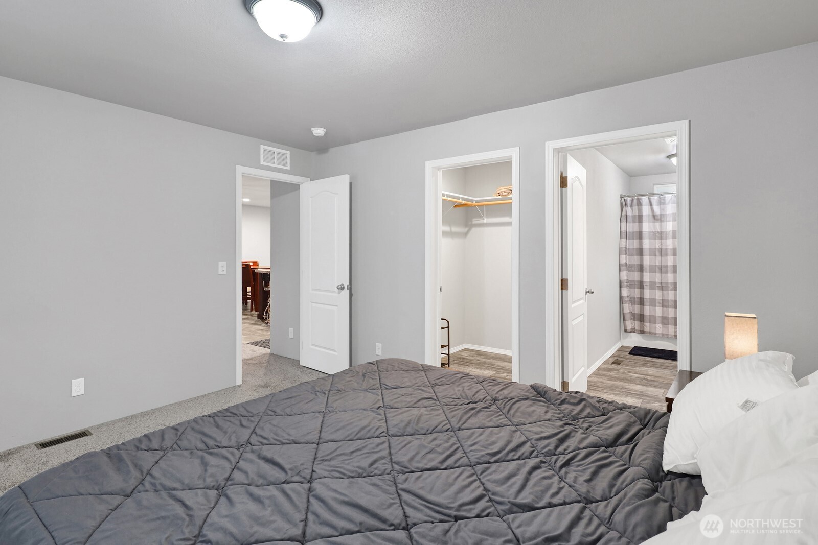 467 Cain Lake Road Sedro-Woolley, WA 98284 - Photo 18 of 28 a bedroom with a bed and a chandelier