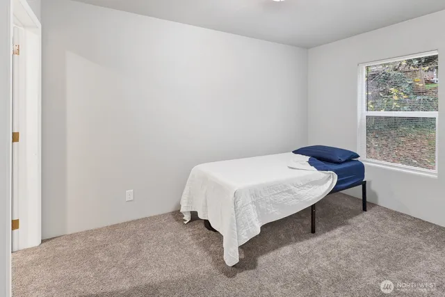 a bedroom with a bed and a window