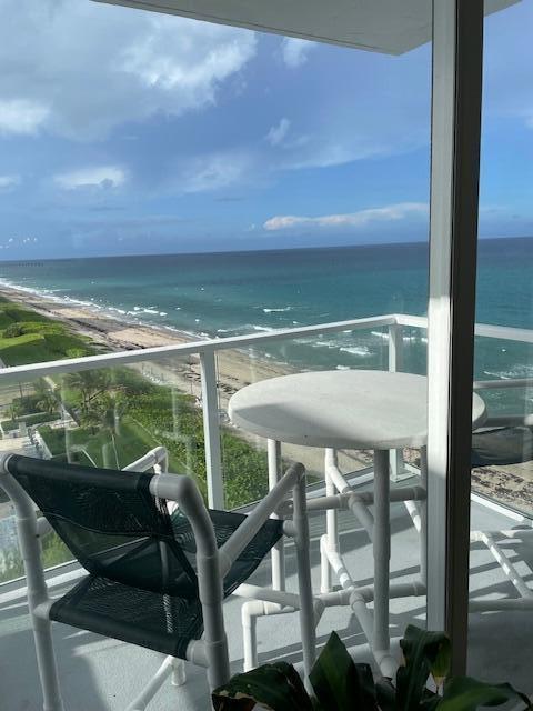 a view of a balcony with chairs and wooden floor
