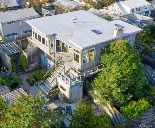 an aerial view of a house with a yard and potted plants