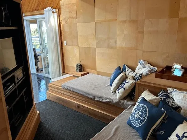 a bed sitting in a bedroom next to a window