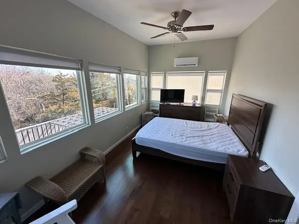 a dining room with a table chairs and a flat screen tv