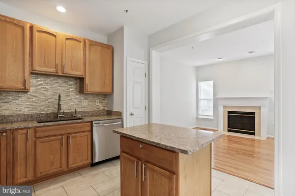 a kitchen with stainless steel appliances granite countertop a stove sink and cabinets