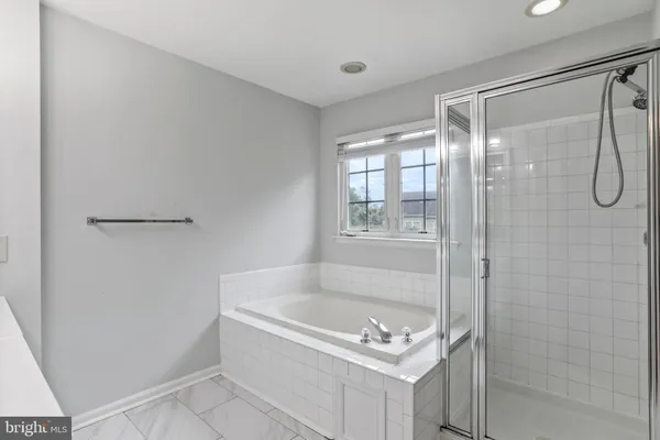a bathroom with a tub and shower