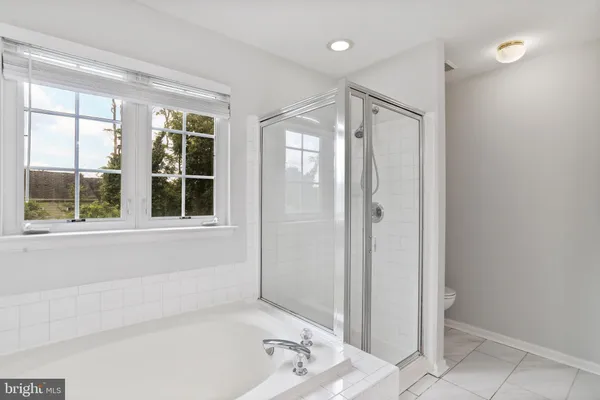 a bathroom with a bathtub and a shower