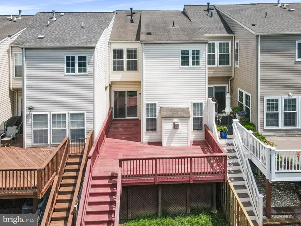 a view of a house with pool and deck