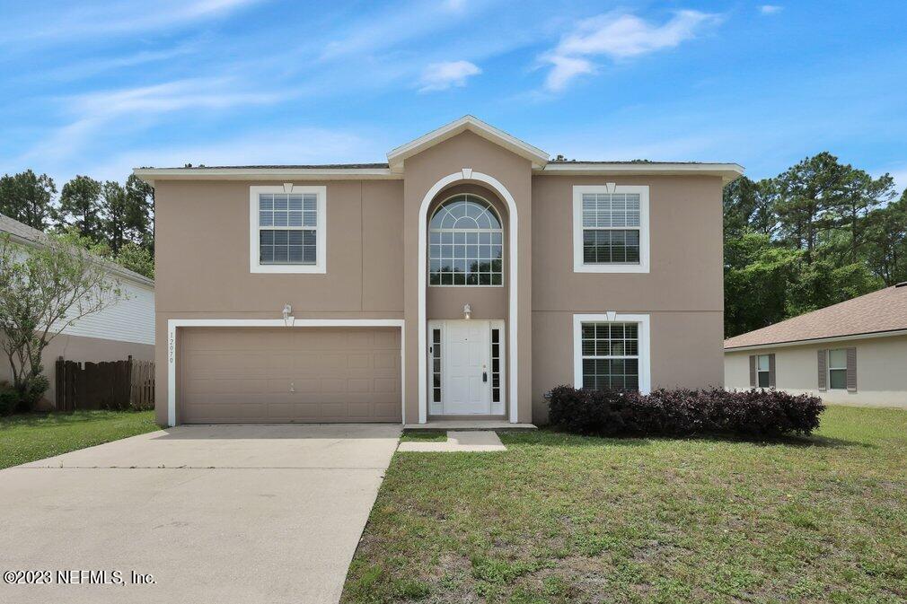 a front view of a house with a garden