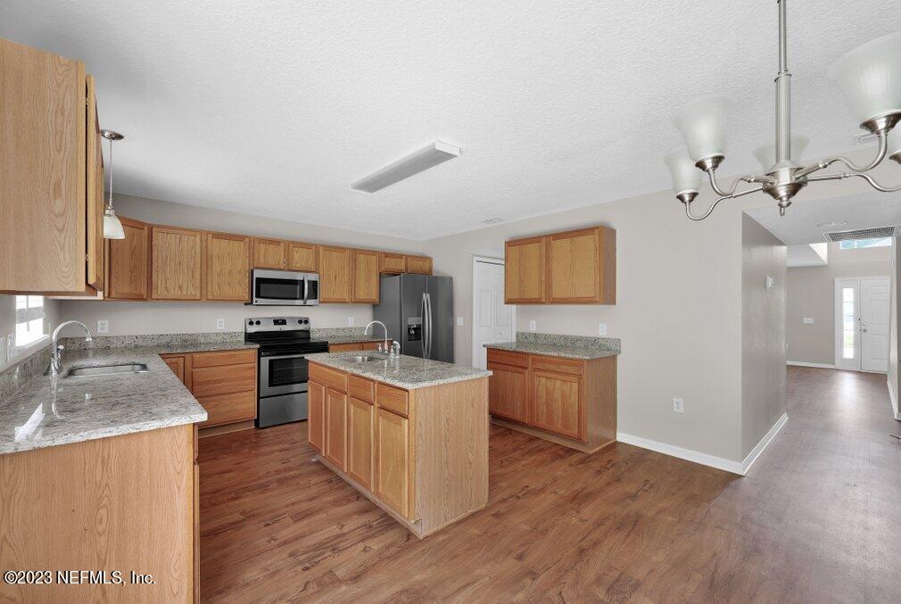12070 Chester Creek Road Jacksonville, FL 32218 - Photo 14 of 45 a kitchen with stainless steel appliances granite countertop a sink stove and refrigerator