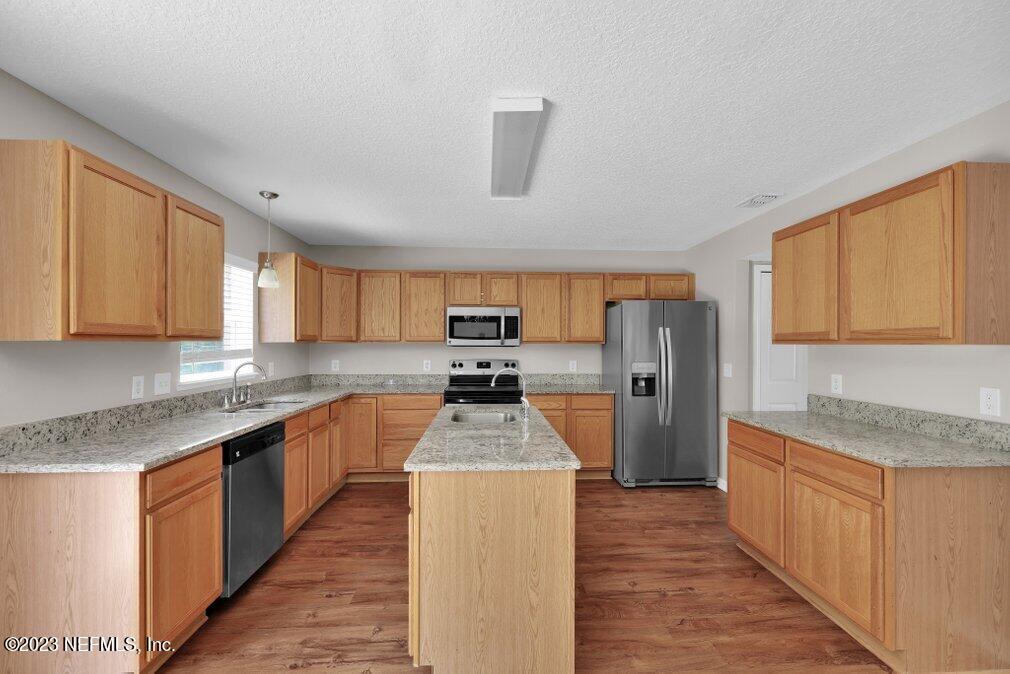 12070 Chester Creek Road Jacksonville, FL 32218 - Photo 15 of 45 a kitchen with a sink stove and refrigerator