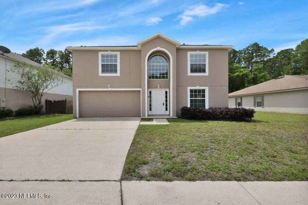 12070 Chester Creek Road Jacksonville, FL 32218 - Photo 2 of 45 a front view of a house with garden