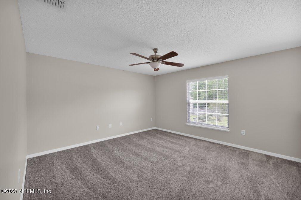 12070 Chester Creek Road Jacksonville, FL 32218 - Photo 26 of 45 wooden floor in an empty room with a window