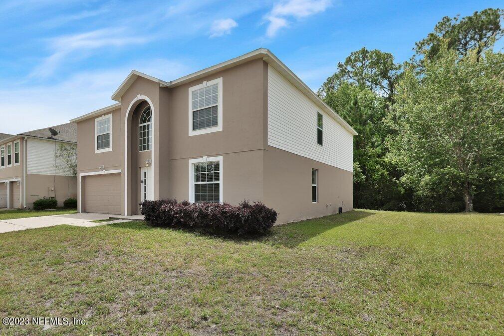 12070 Chester Creek Road Jacksonville, FL 32218 - Photo 3 of 45 a front view of a house with a yard