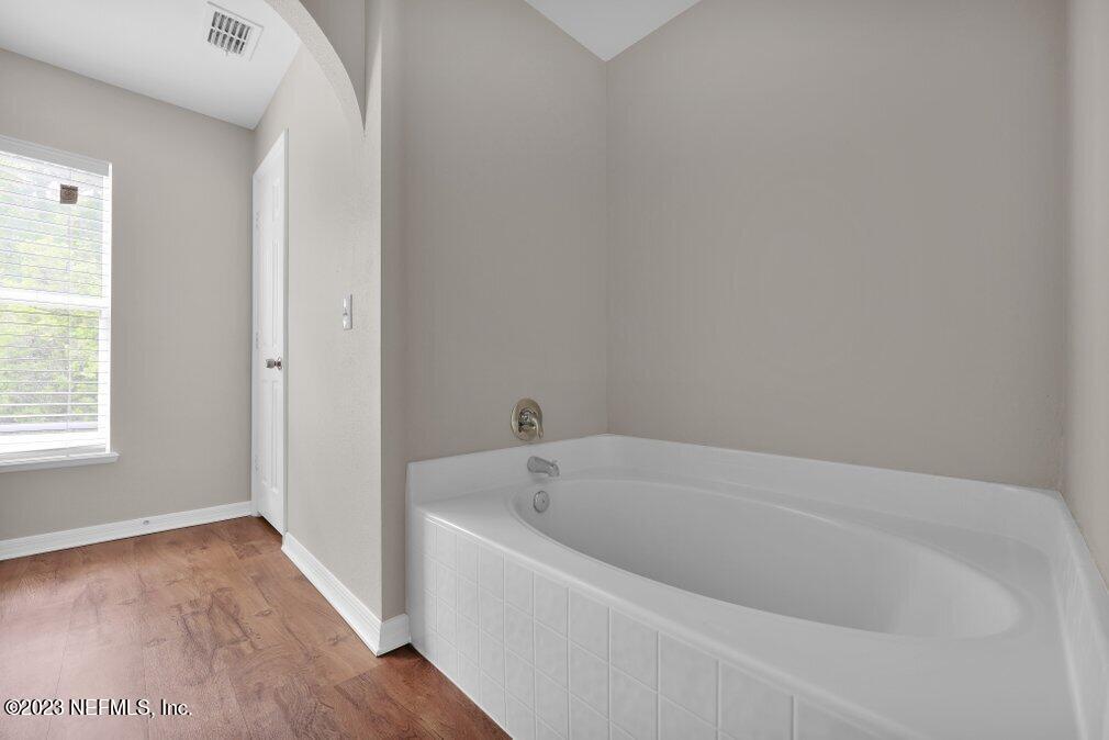 12070 Chester Creek Road Jacksonville, FL 32218 - Photo 33 of 45 a white bath tub sitting in a bathroom