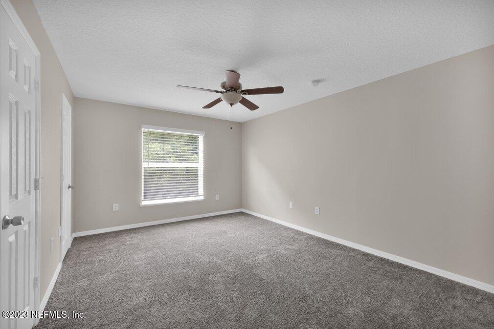 12070 Chester Creek Road Jacksonville, FL 32218 - Photo 36 of 45 a view of room with a ceiling fan and window