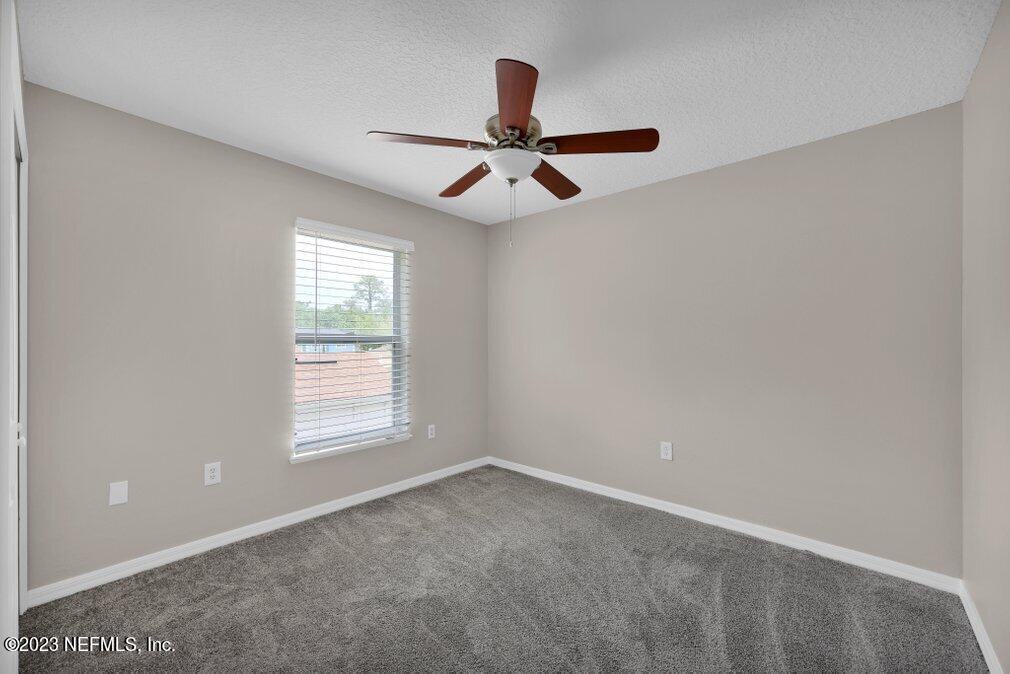 12070 Chester Creek Road Jacksonville, FL 32218 - Photo 38 of 45 an empty room with windows and fan