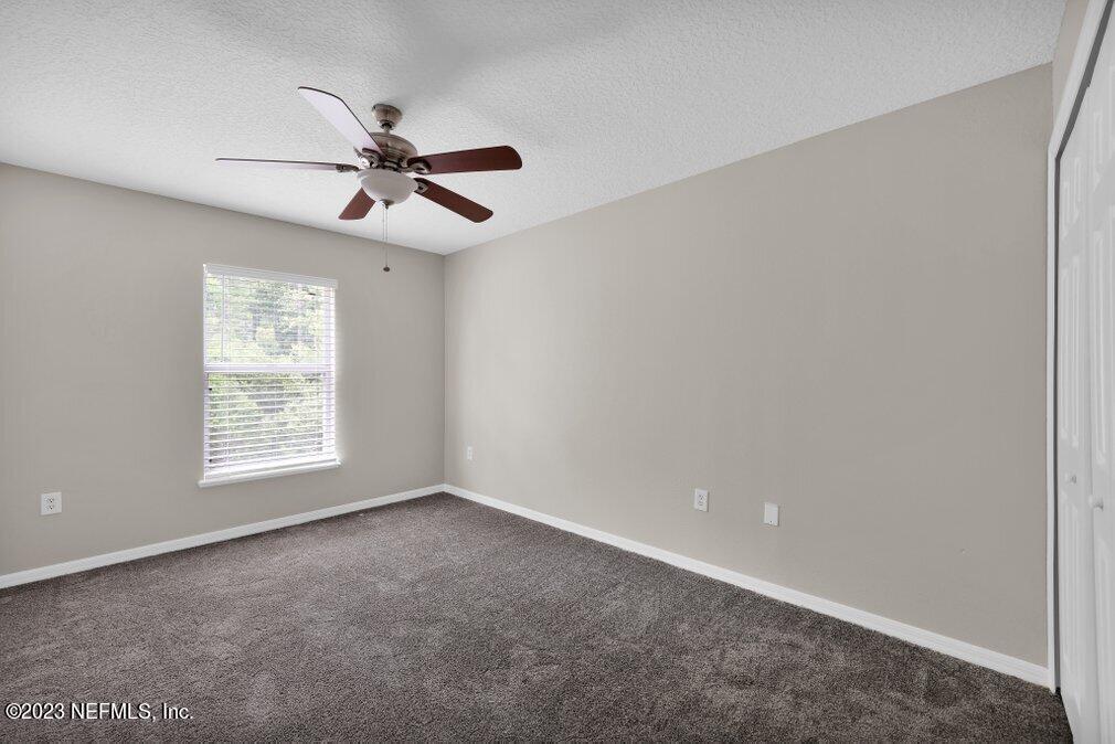 12070 Chester Creek Road Jacksonville, FL 32218 - Photo 39 of 45 an empty room with windows and fan