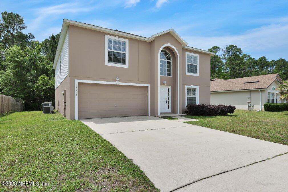12070 Chester Creek Road Jacksonville, FL 32218 - Photo 4 of 45 a front view of a house with a yard and garage