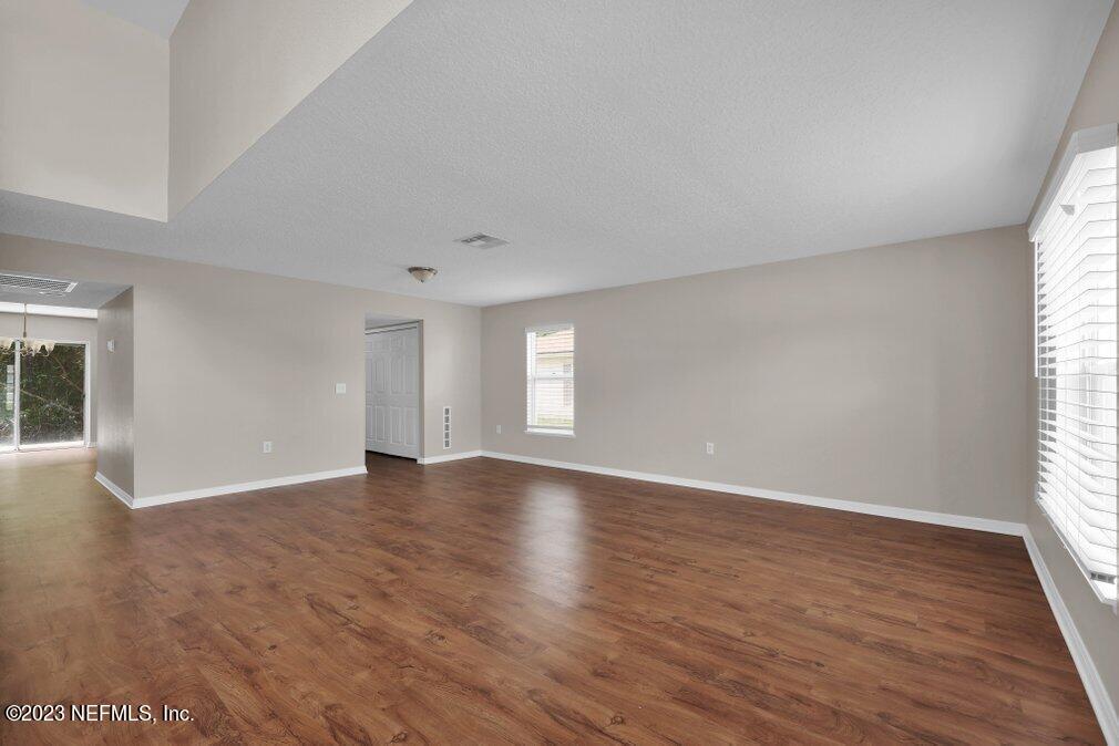 12070 Chester Creek Road Jacksonville, FL 32218 - Photo 8 of 45 an empty room with wooden floor and windows