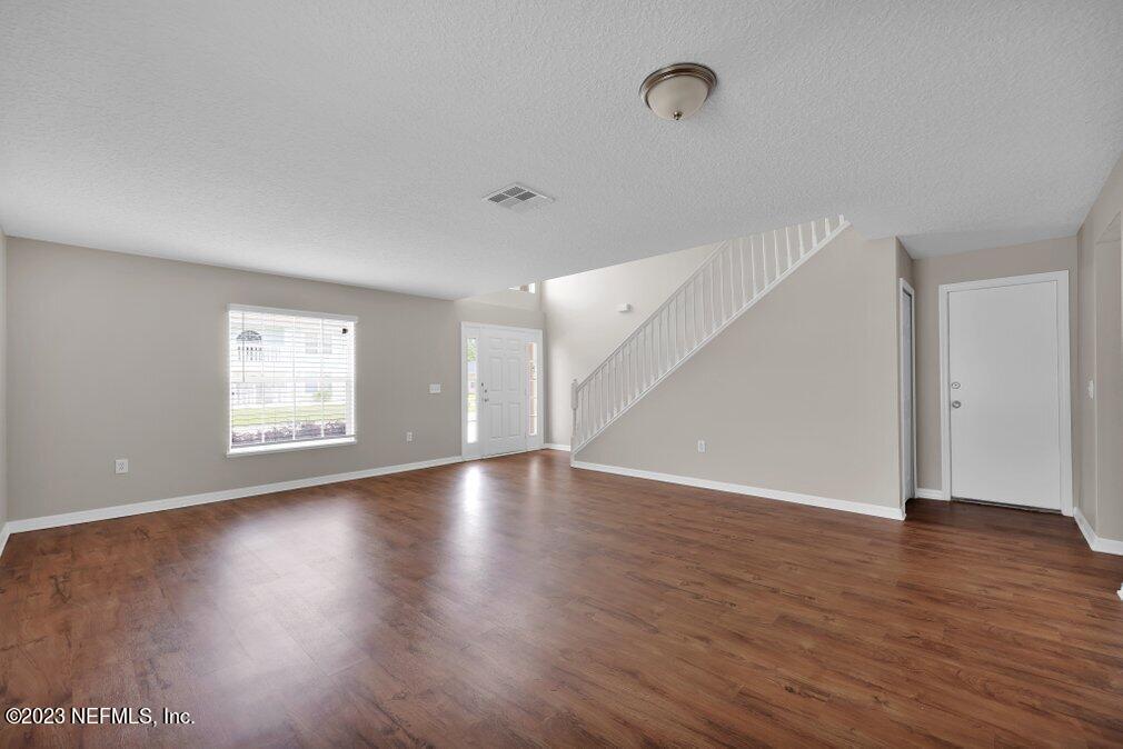 12070 Chester Creek Road Jacksonville, FL 32218 - Photo 10 of 45 a view of an empty room with wooden floor and a window