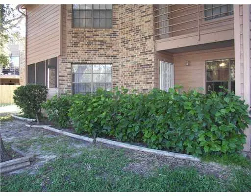 a view of a brick house with a yard