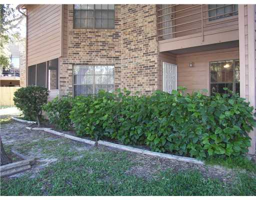 a view of a brick house with a yard