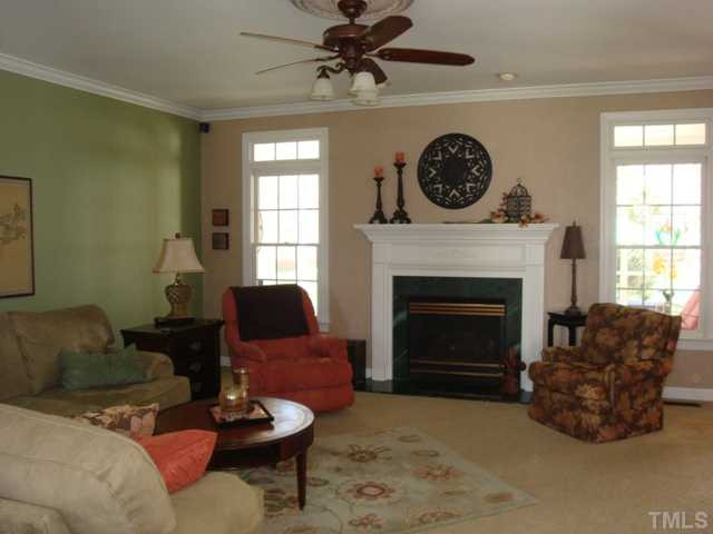 2845 Anfield Road Raleigh, NC 27606 - Photo 4 of 25 Family Room has Gas Fireplace, Crown Moulding and Windows offer Plenty of Light with Transoms Den/Family/Great Room