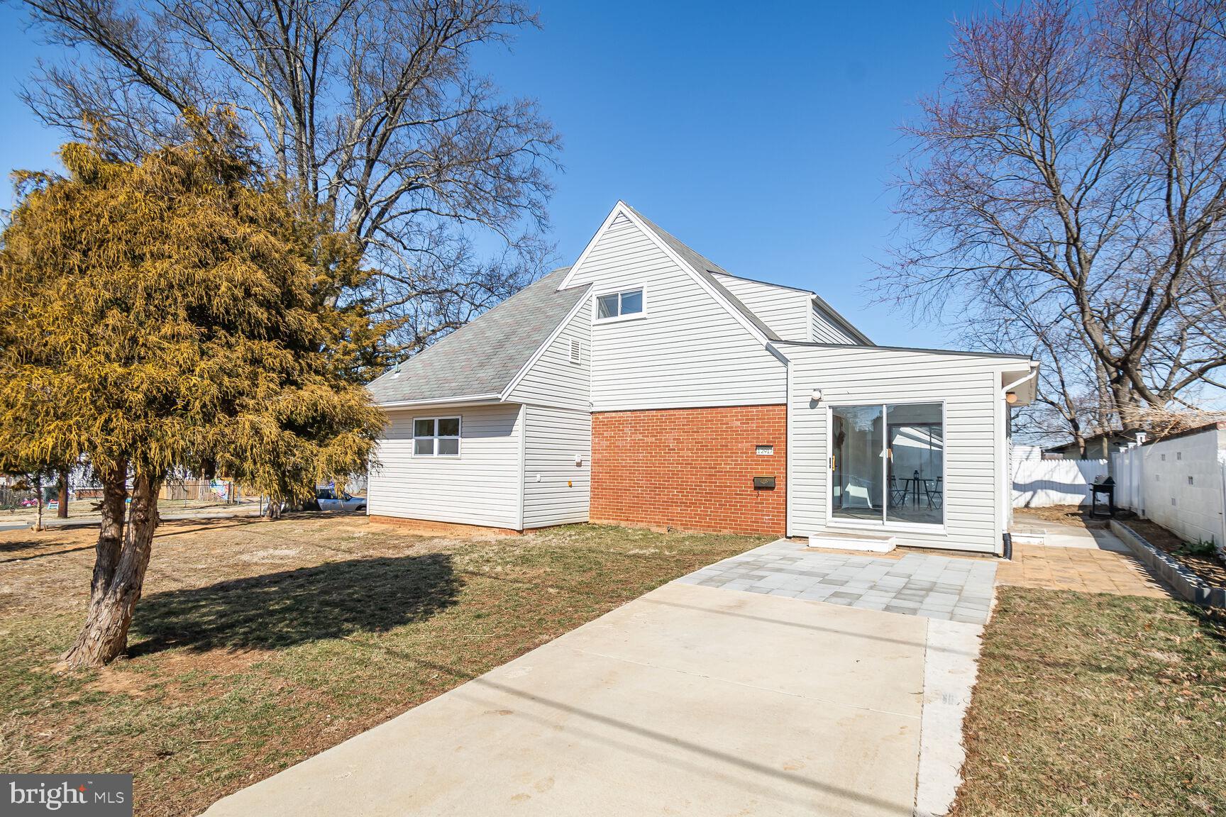 12917 Estelle Road Silver Spring, MD 20906 - Photo 1 of 28 a front view of a house with a yard and garage