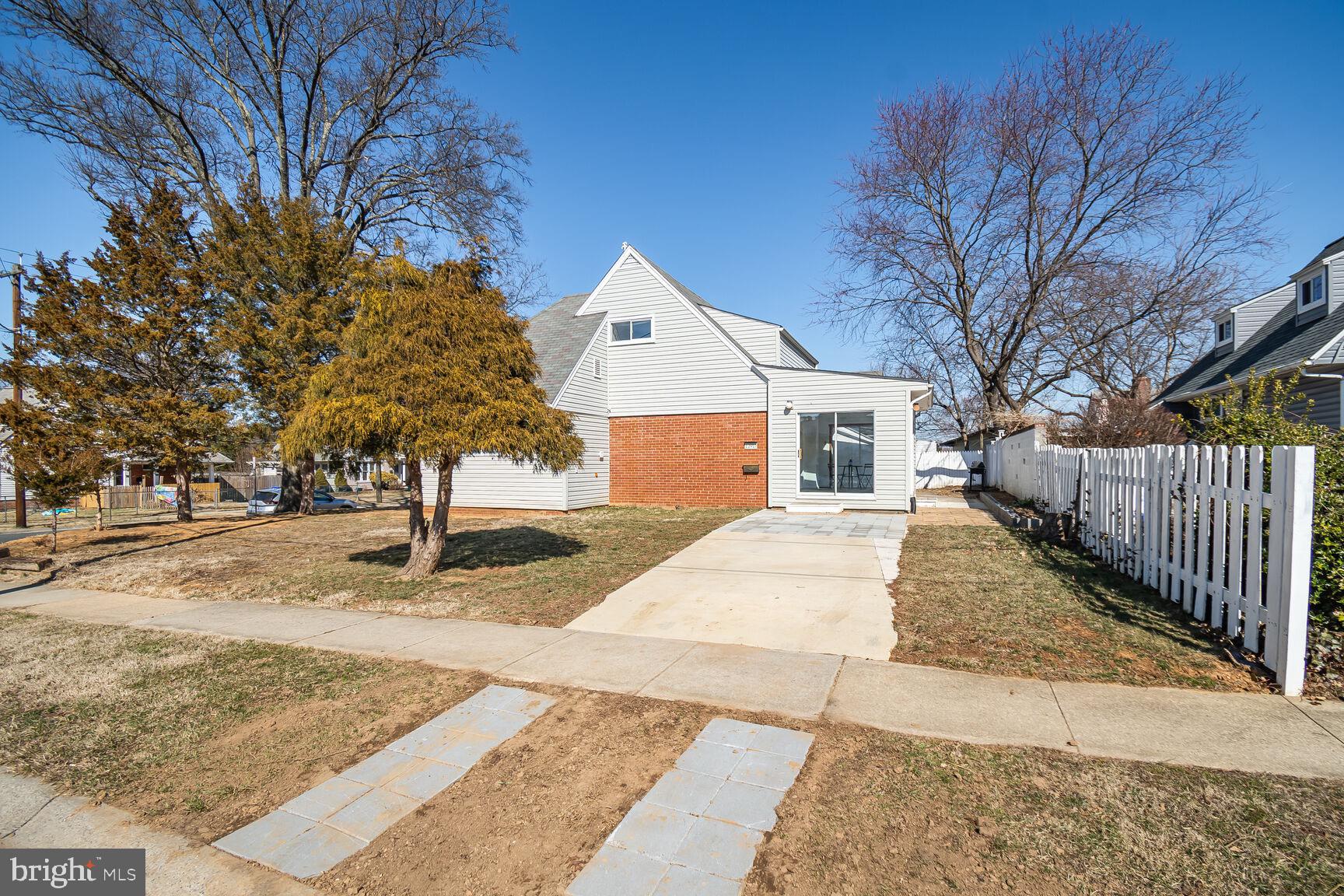12917 Estelle Road Silver Spring, MD 20906 - Photo 24 of 28 a front view of a house with a yard and garage