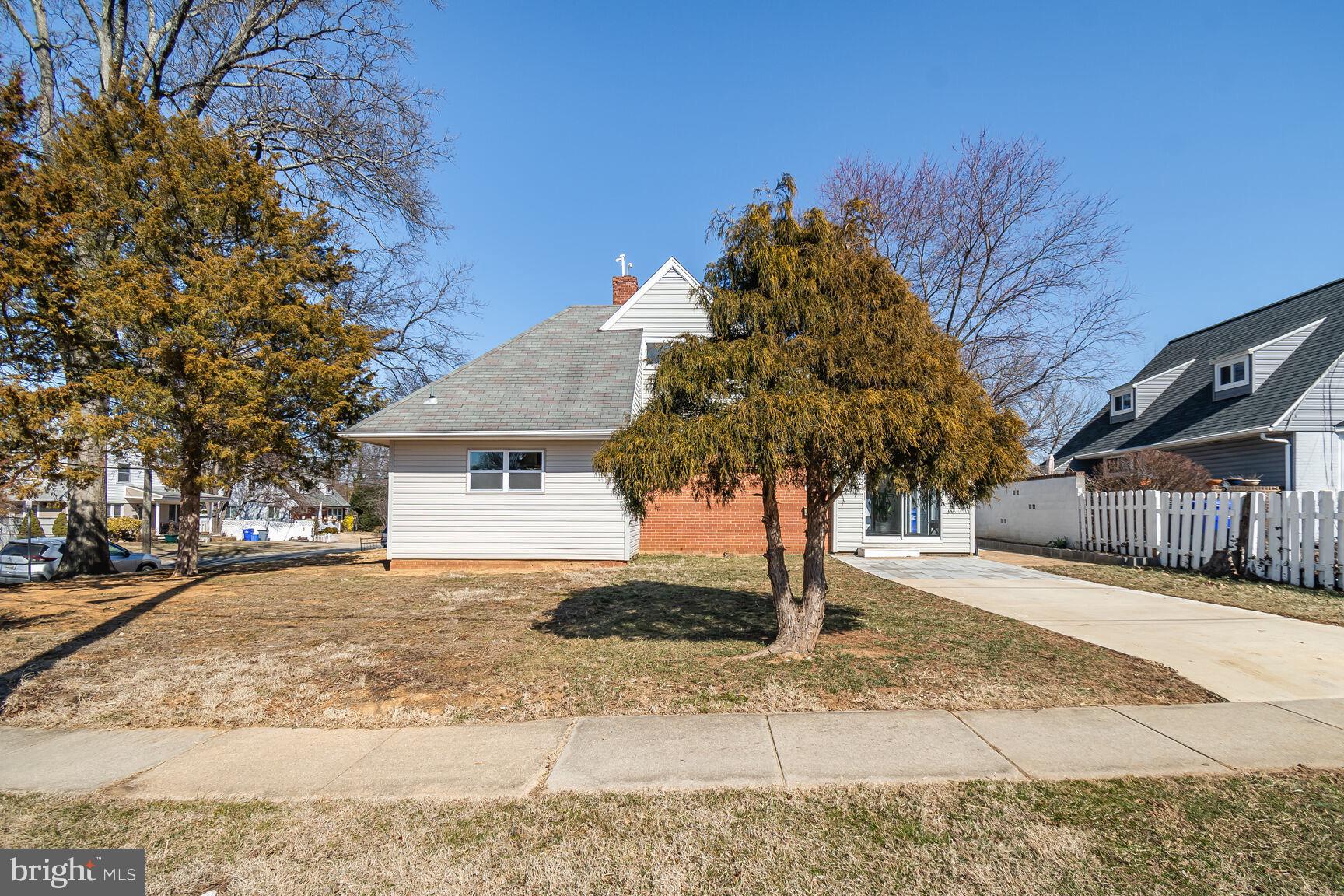 12917 Estelle Road Silver Spring, MD 20906 - Photo 25 of 28 a front view of a house with a yard and garage
