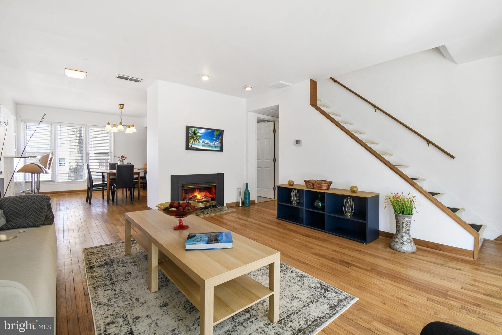 12917 Estelle Road Silver Spring, MD 20906 - Photo 7 of 28 a living room with furniture and a fireplace