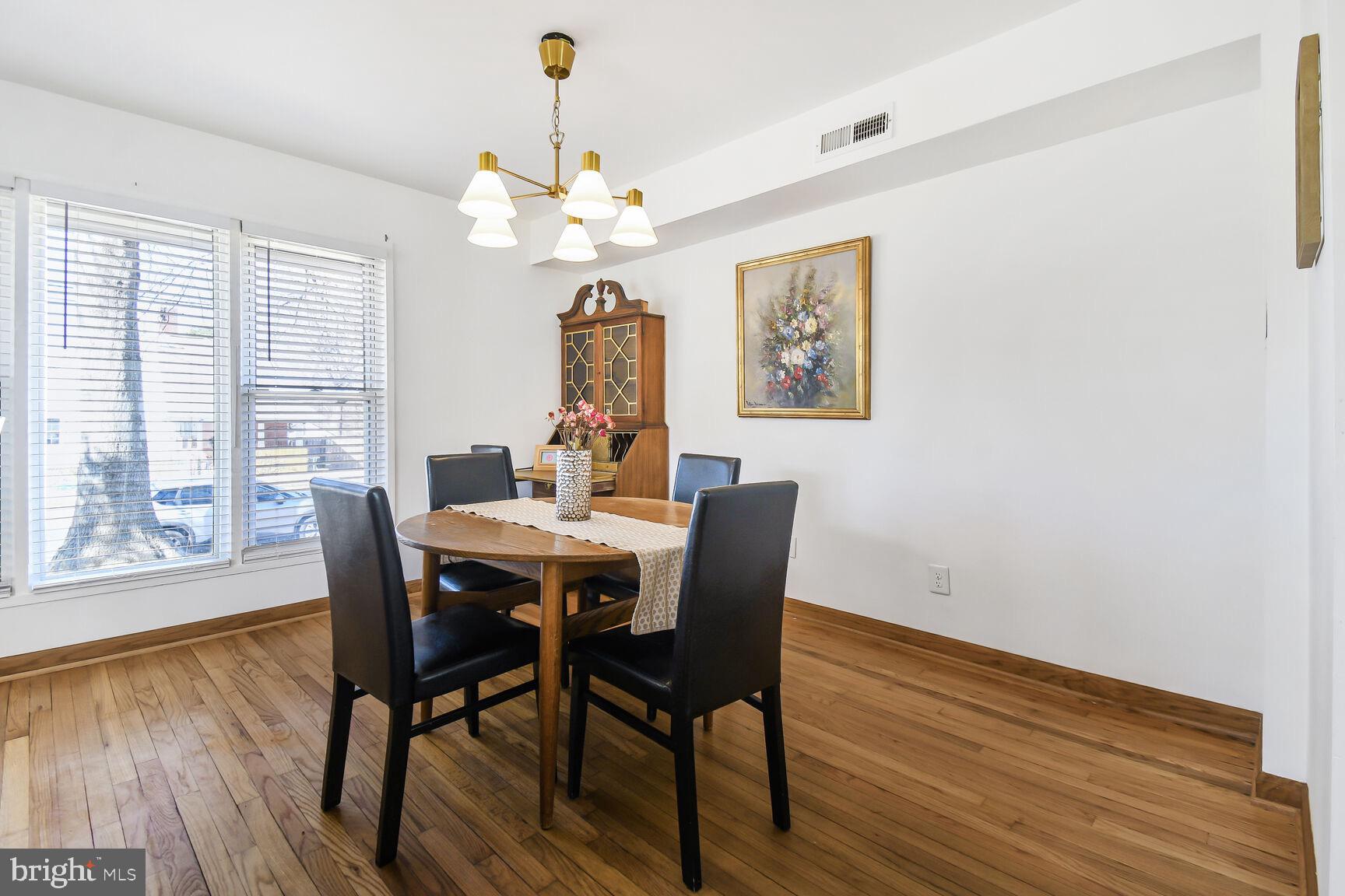 12917 Estelle Road Silver Spring, MD 20906 - Photo 9 of 28 a view of a dining room with furniture window and wooden floor