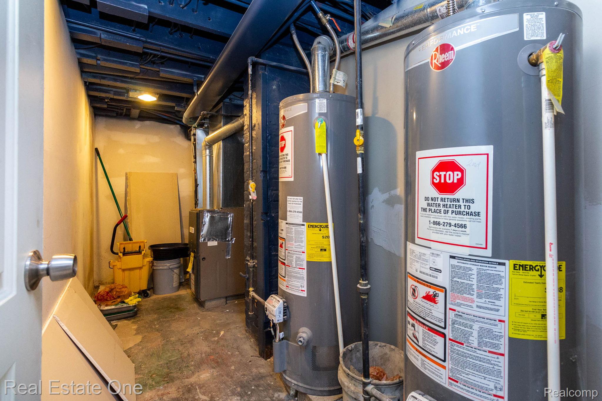 5485 Springwells Street Detroit, MI 48210 - Photo 44 of 47 Utility area featuring two hot water heaters, exposed ductwork, a furnace unit, and concrete flooring
