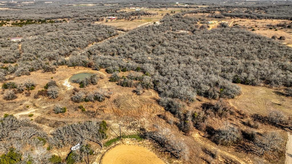 1150 Dps Tower Road, Unit LOT 50 Perrin, TX 76486 - Photo 2 of 17 a view of a yard covered with snow