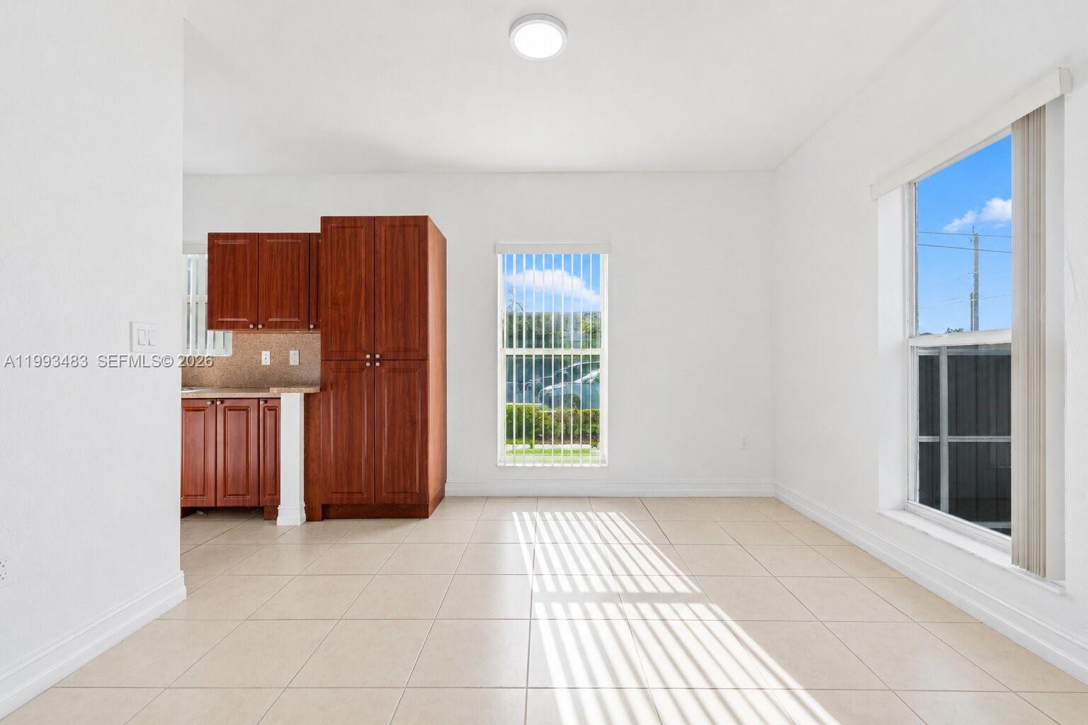 10357 Southwest 178th Street, Unit 10357 Miami, FL 33157 - Photo 11 of 25 a view of kitchen with furniture and window